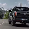 Превью изображения Volkswagen Amarok Dark Label на дороге
