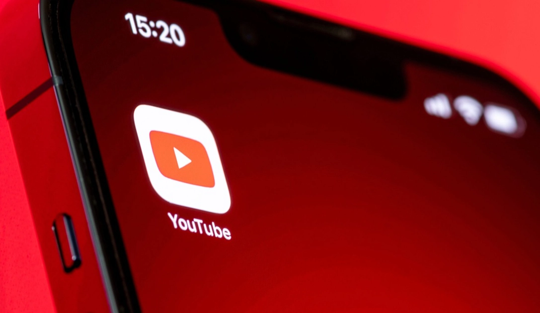 Before and after: the Subscriptions tab moves from the bottom bar to just below the YouTube logo.